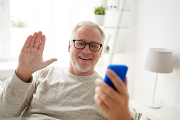 Image showing senior man having video call on smartphone at home