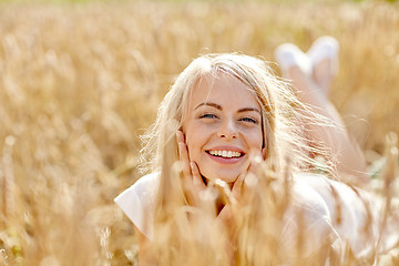 Image showing happy woman or teen girl lying in cereal field