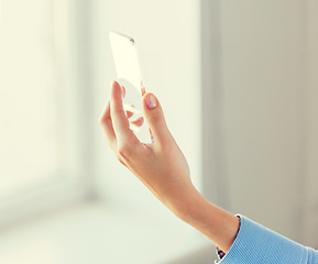 Image showing close up of woman with transparent smartphone