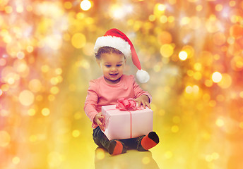 Image showing happy little baby girl with christmas present