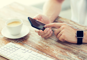 Image showing close up of hands with smart phone and watch