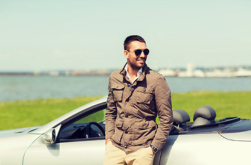 Image showing happy man near cabriolet car outdoors