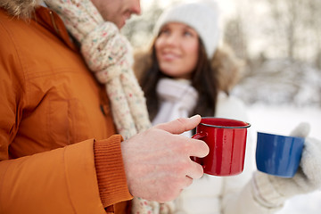 Image showing close up of happy couple with tea cups in winter