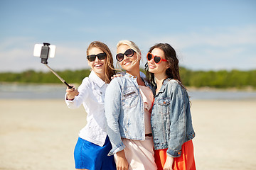 Image showing group of smiling women taking selfie on beach