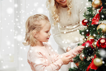 Image showing happy family decorating christmas tree at home