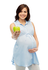 Image showing happy pregnant woman holding green apple