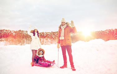 Image showing happy family with sled walking in winter outdoors