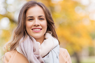 Image showing beautiful happy young woman smiling in autumn park