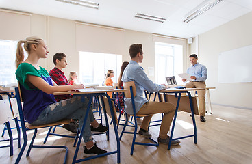 Image showing group of students and teacher with papers or tests