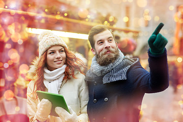 Image showing happy couple walking with tablet pc in old town