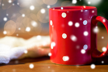 Image showing red polka dot tea cup on wooden table