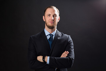 Image showing happy businessman in suit over black background