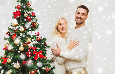 Image showing happy couple hugging near christmas tree at home