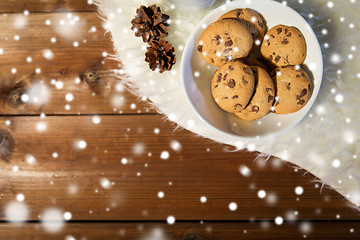 Image showing close up of cookies in bowl and cones on fur rug