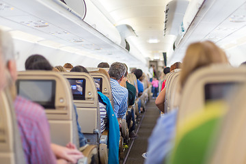 Image showing Interior of airplane with passengers on seats waiting to taik off.