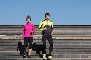 Image showing young  couple jogging on steps