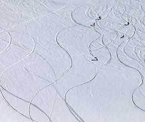 Image showing Snowboarders and skiers downhill on off piste slope