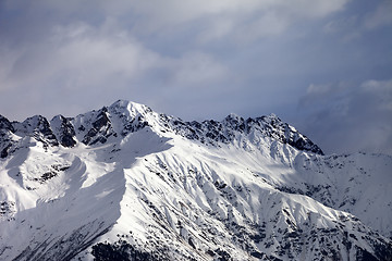 Image showing Snow sunlight mountain and cloudy sky at winter evening