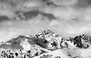 Image showing Black and white snow slope and winter sunlight mountains in clou