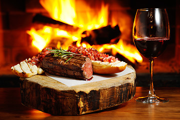 Image showing tasty steak on a background of fire