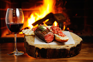 Image showing tasty steak on a background of fire