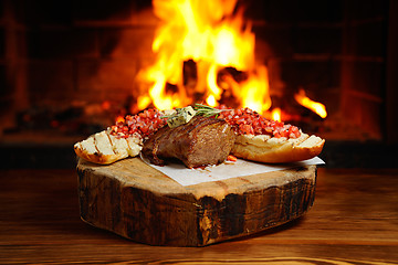 Image showing tasty steak on a background of fire