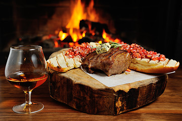 Image showing tasty steak on a background of fire