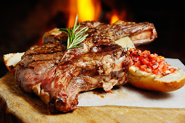 Image showing tasty steak on a background of fire