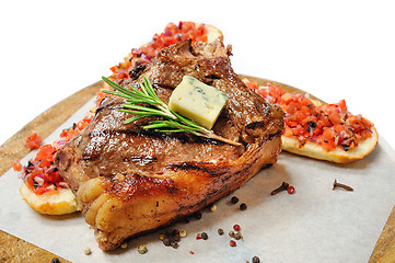 Image showing fried steak on a wooden board