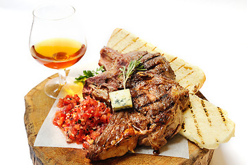 Image showing fried steak on a wooden board