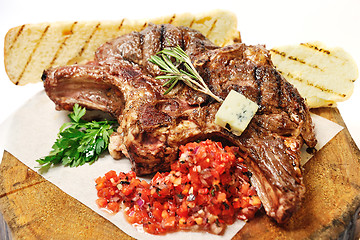 Image showing fried steak on a wooden board