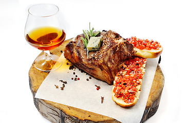 Image showing fried steak on a wooden board