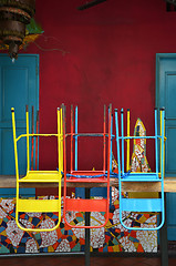 Image showing Colorful chairs on a wooden table