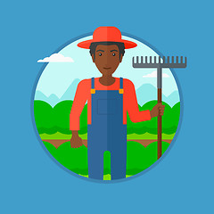 Image showing Farmer with rake at cabbage field.