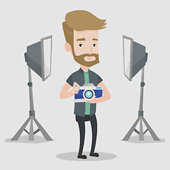 Image showing Photographer with camera in photo studio.