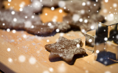 Image showing close up of ginger dough, molds and flour on board