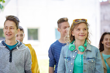 Image showing group of happy teenage students walking outdoors