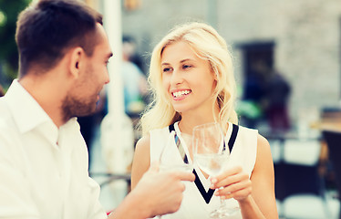Image showing smiling couple drinking champagne at cafe