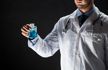 Image showing close up of doctor holding flask with cure vaccine