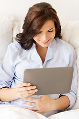 Image showing happy pregnant woman with tablet pc at home