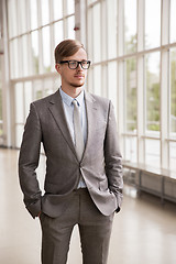 Image showing young businessman in suit and glasses at office