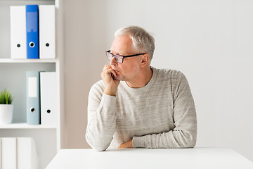 Image showing senior man sitting at table