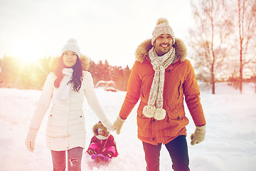 Image showing happy family with sled walking in winter outdoors