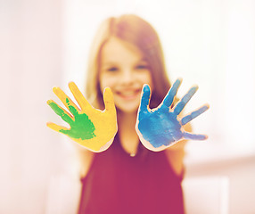 Image showing happy girl showing painted hands