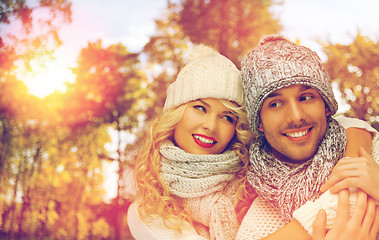 Image showing happy couple in warm clothes over autumn