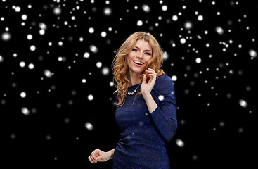 Image showing happy young woman dancing over snow