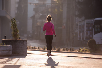 Image showing sporty woman jogging on morning