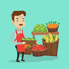 Image showing Supermarket worker with box full of apples.