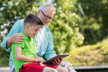 Image showing happy grandfather and boy with tablet pc outdoors