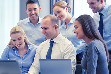 Image showing smiling business people with laptop computer